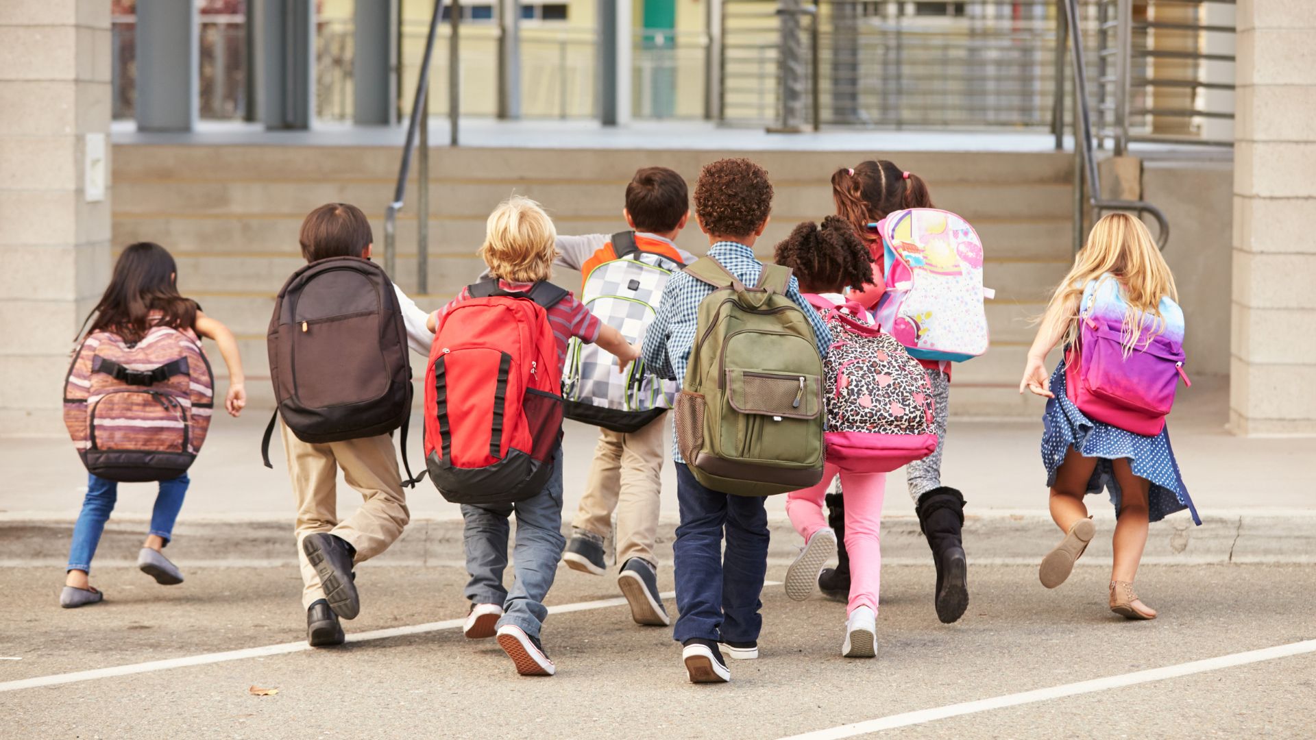 Back to School Health Tips from Pediatricians A Checklist for Ventura County Families Group of elementary school children with backpacks walking toward school building on the first day of class